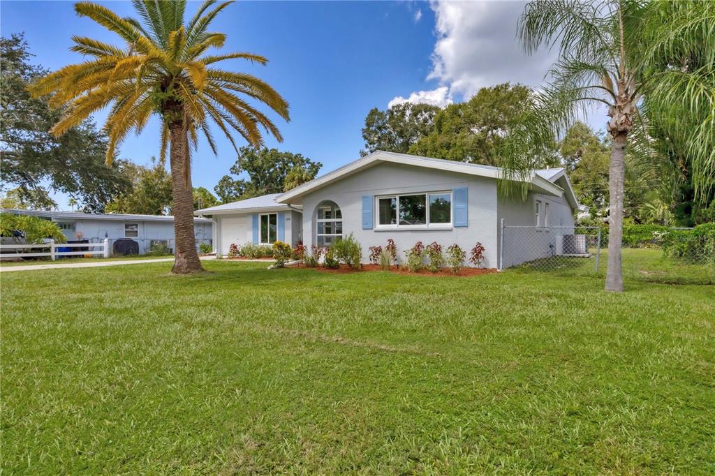 a front view of house with yard and green space