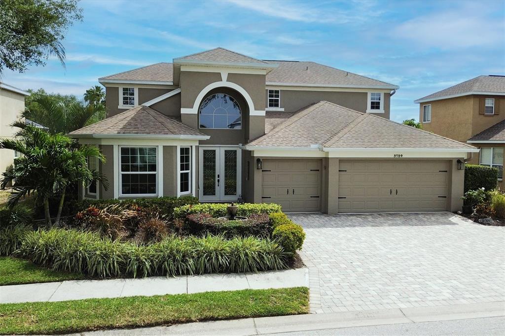 a front view of a house with a yard and garage