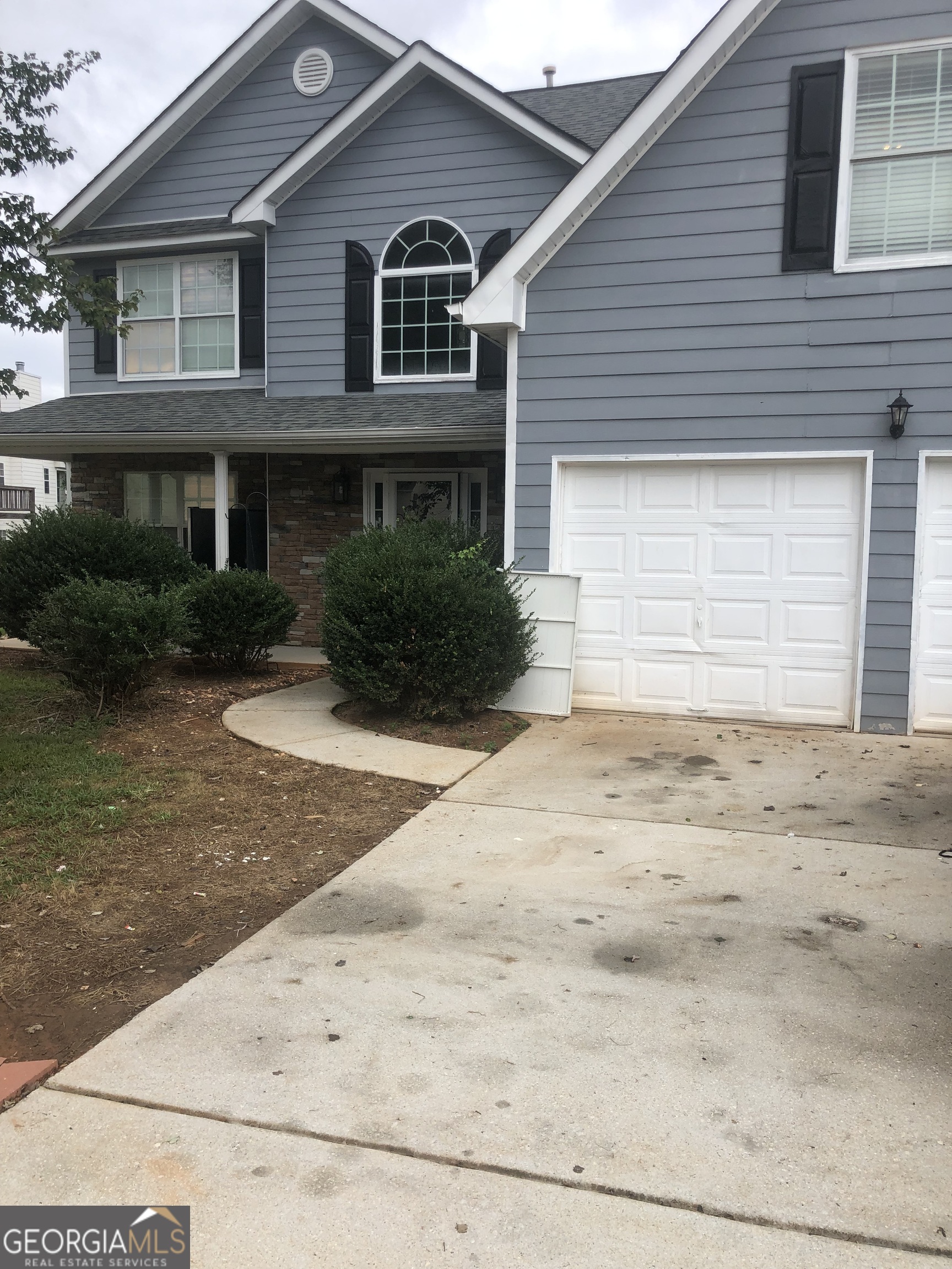 a front view of a house with a yard