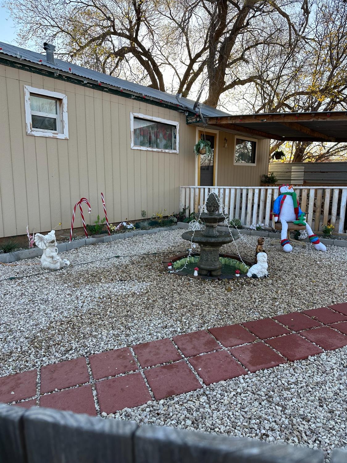 a backyard of a house with barbeque oven