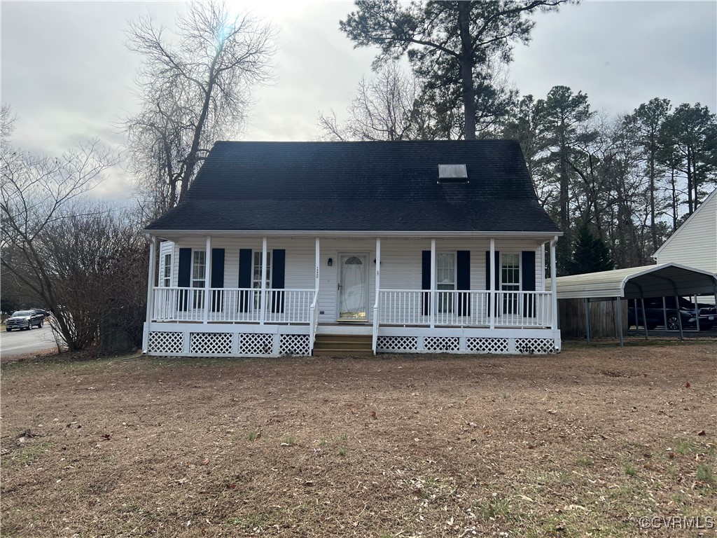 View of front of home featuring a carport and a po