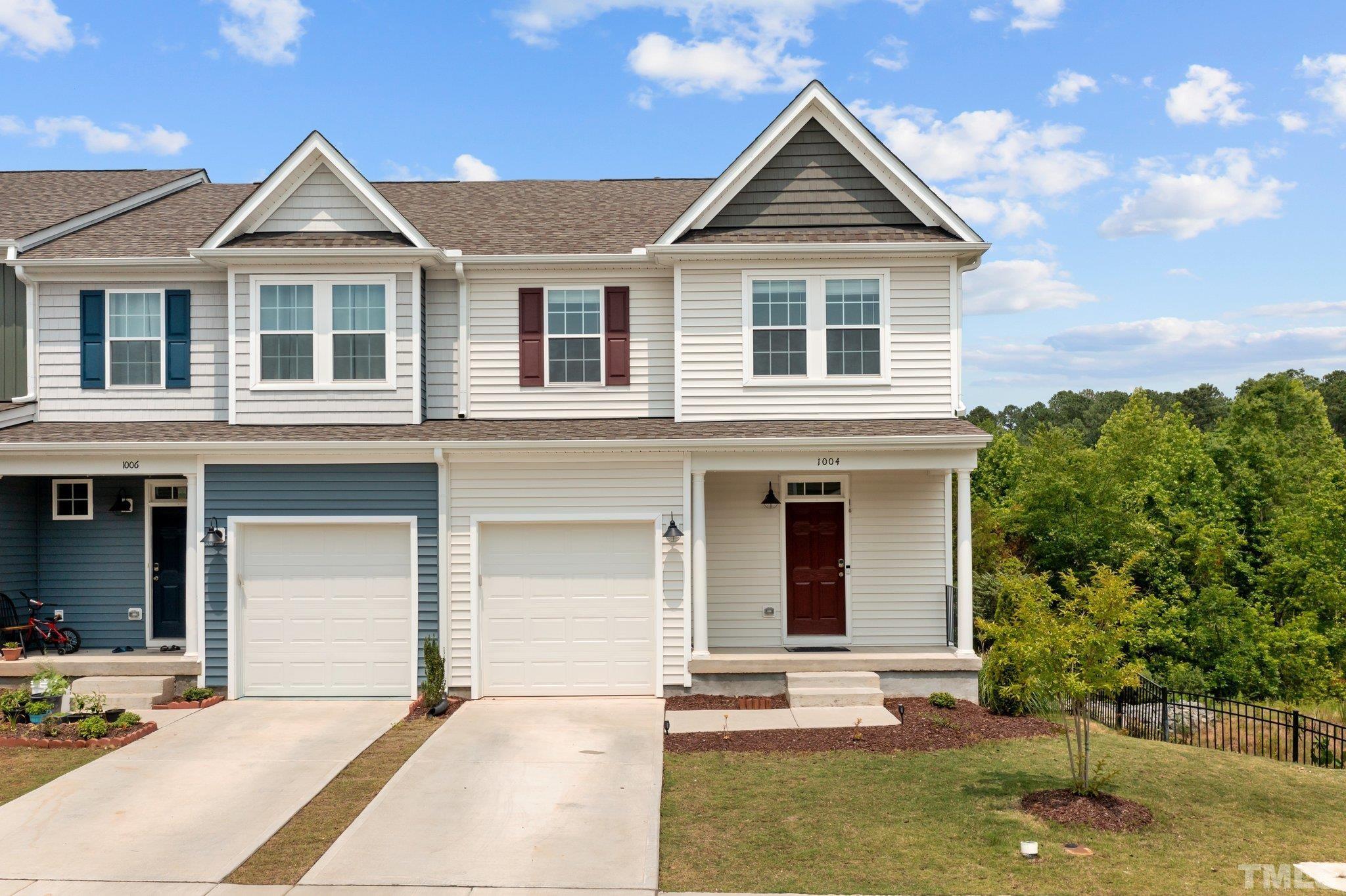 a front view of a house with a yard garage and outdoor seating