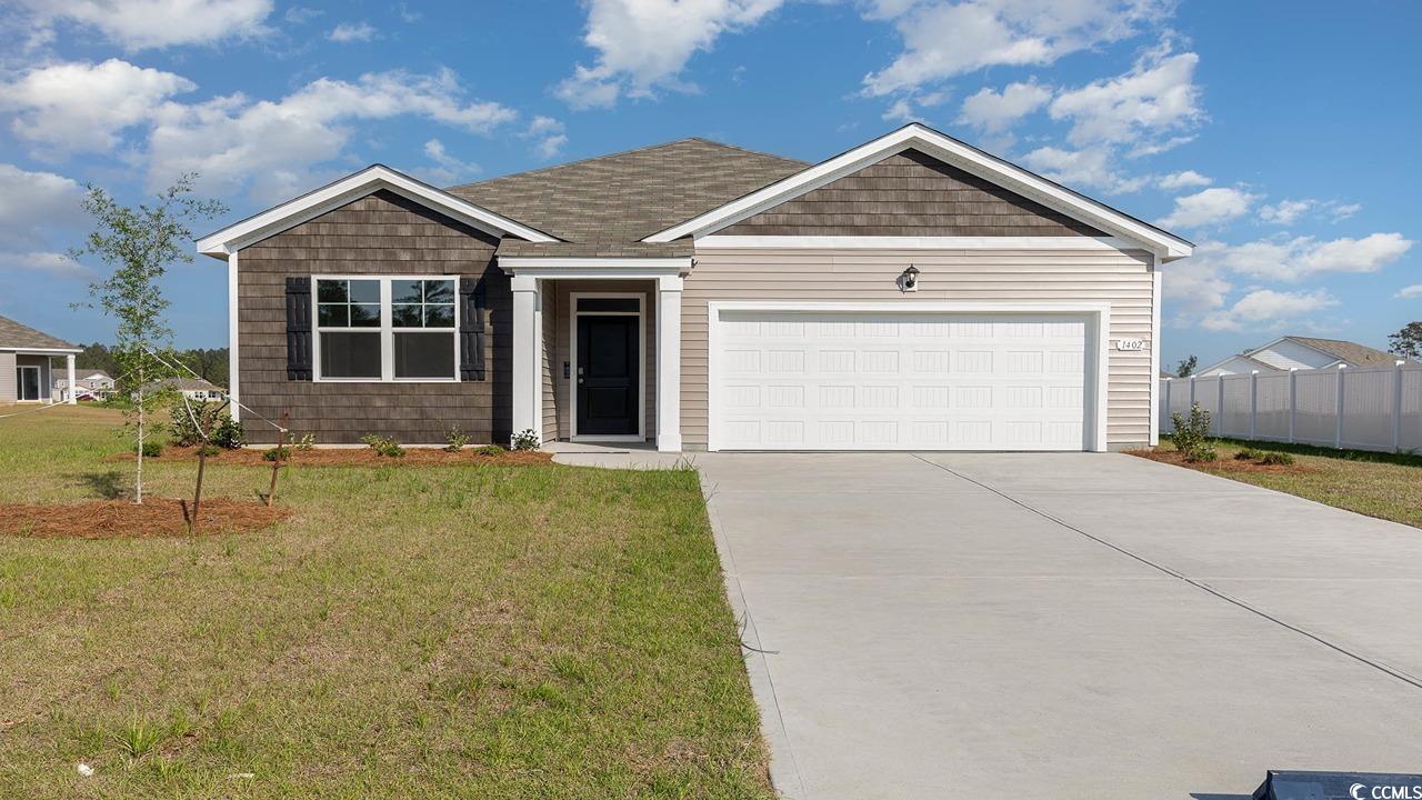 View of front facade featuring a garage and a fron