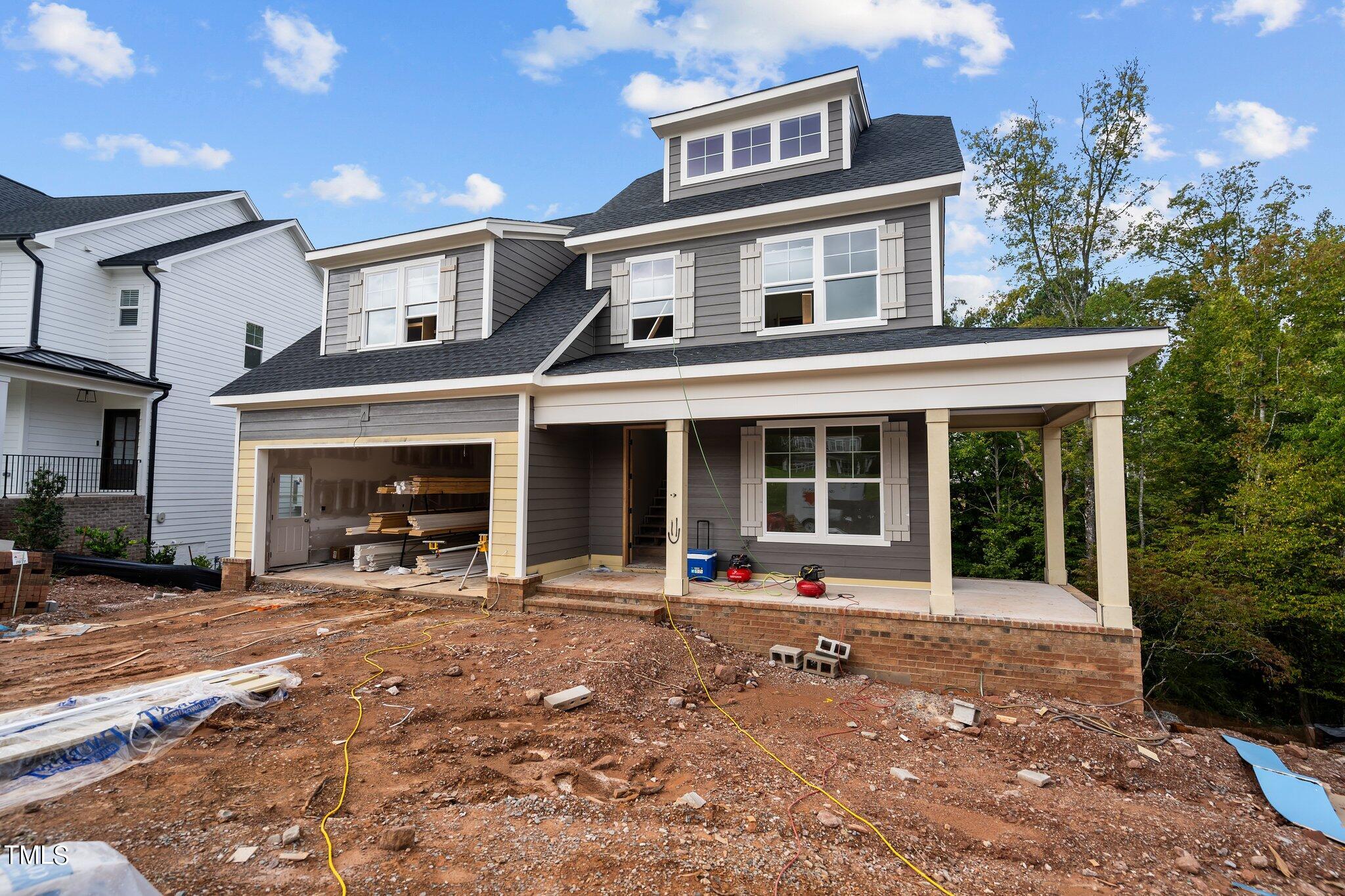 a front view of a house with outdoor seating