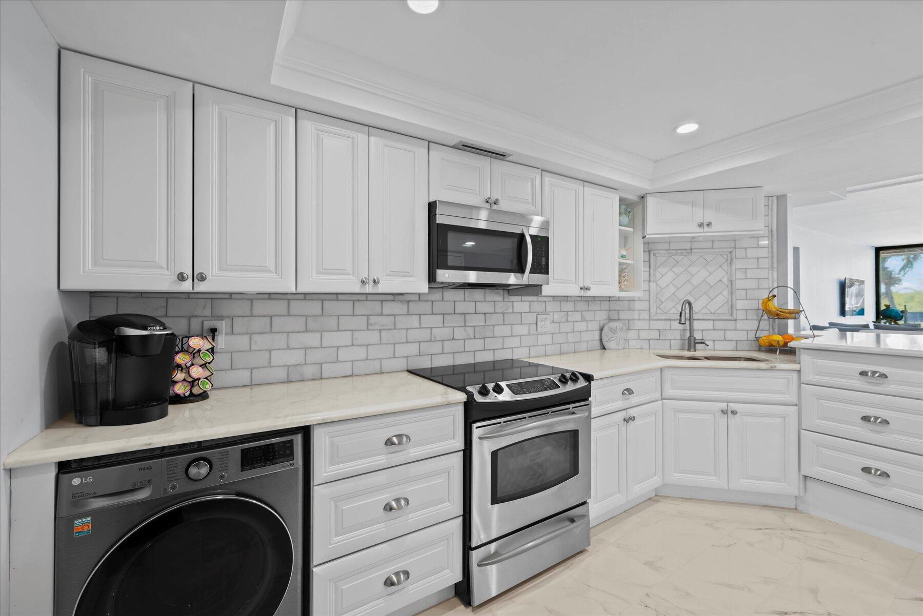 a kitchen with cabinets stainless steel appliances and sink