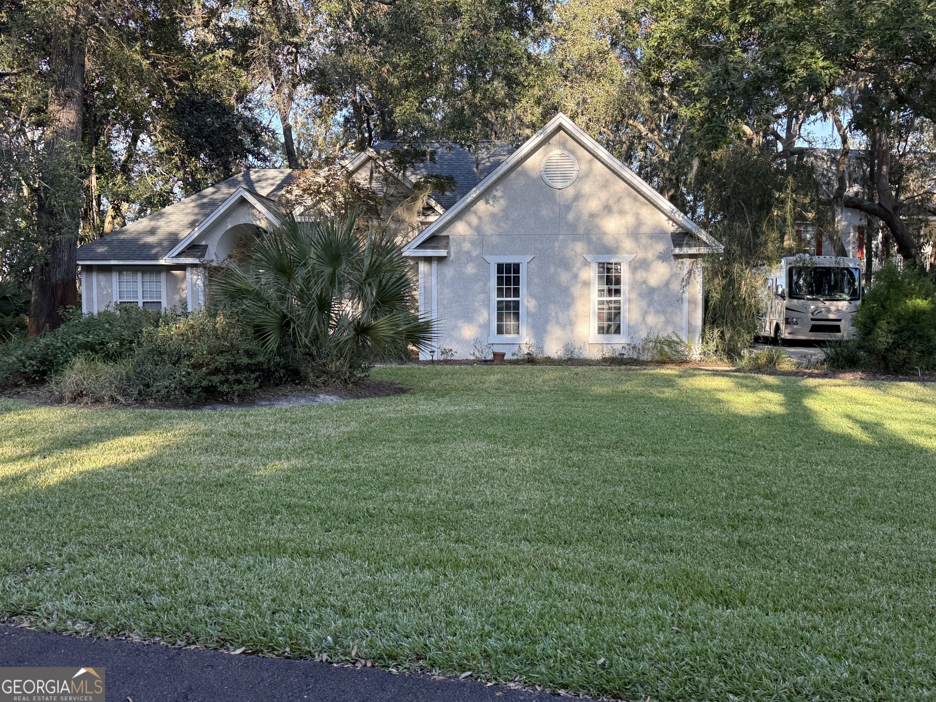 a front view of house with yard and trees