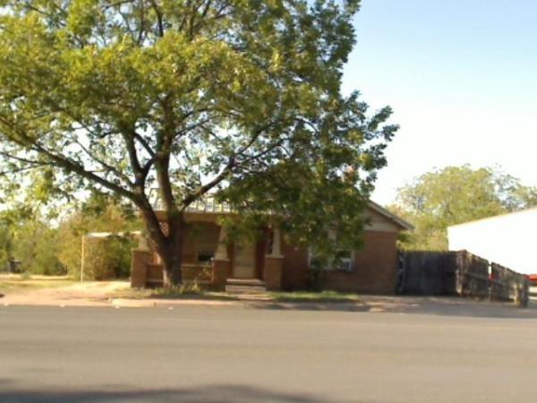 a view of a trees and brick walls