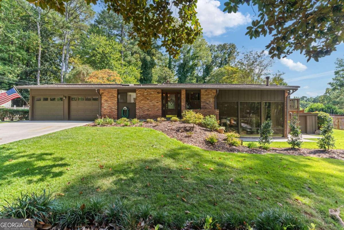 a view of a house with backyard porch and sitting area