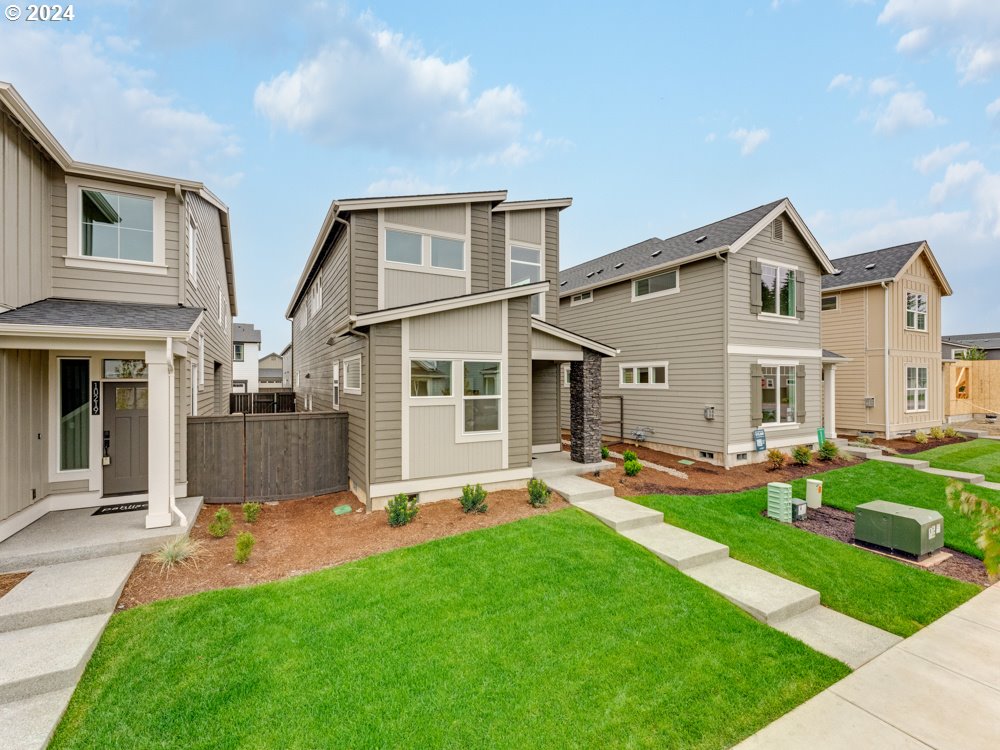 a front view of house with yard and green space