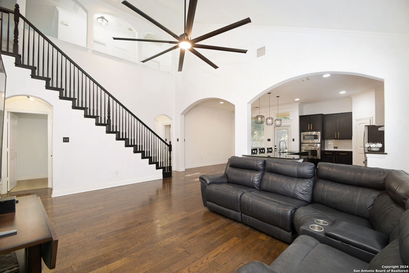 a living room with furniture or wooden floor and a large window