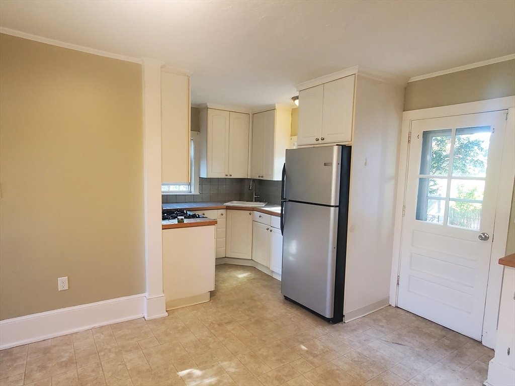 a kitchen with refrigerator a stove a microwave and cabinets