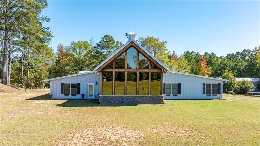 a front view of house with yard outdoor seating and barbeque oven