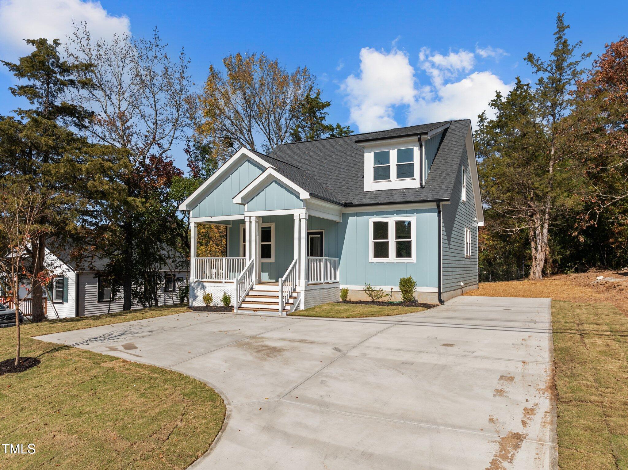 a view of a house with backyard porch and sitting area