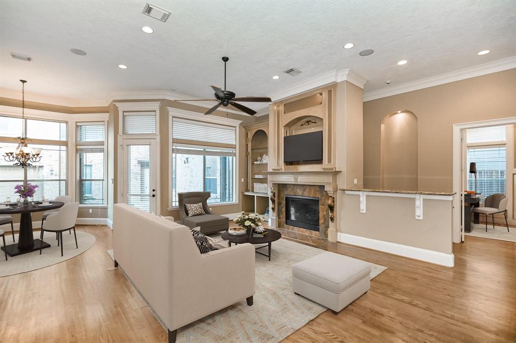 a living room with furniture fireplace and flat screen tv