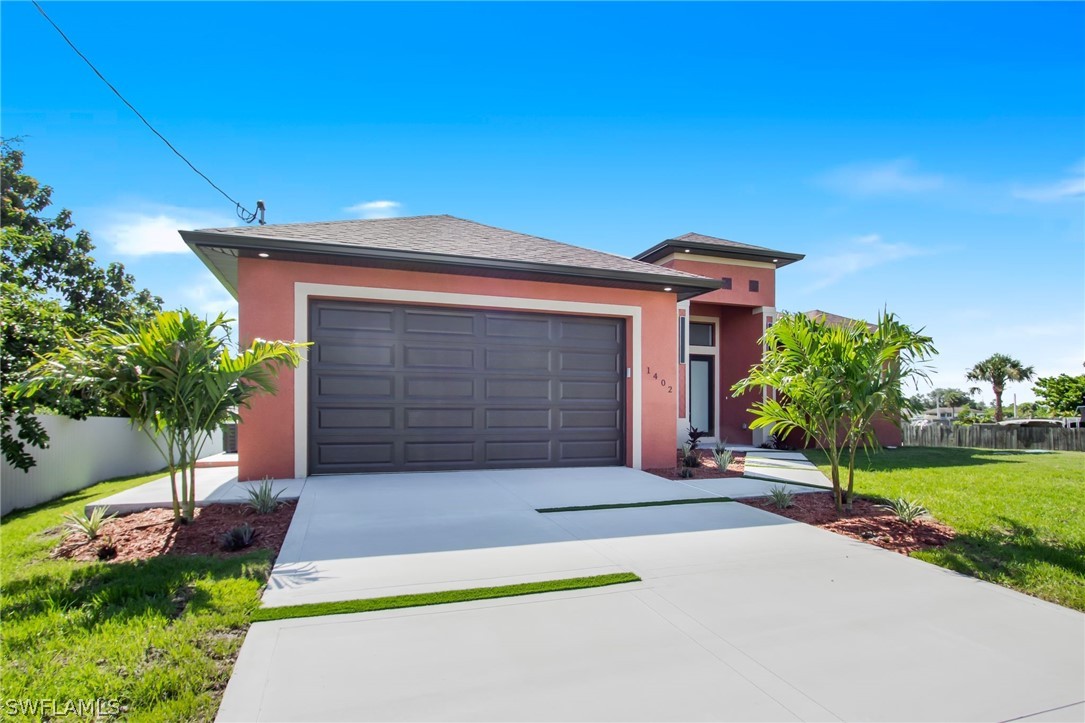 a front view of a house with a yard and garage