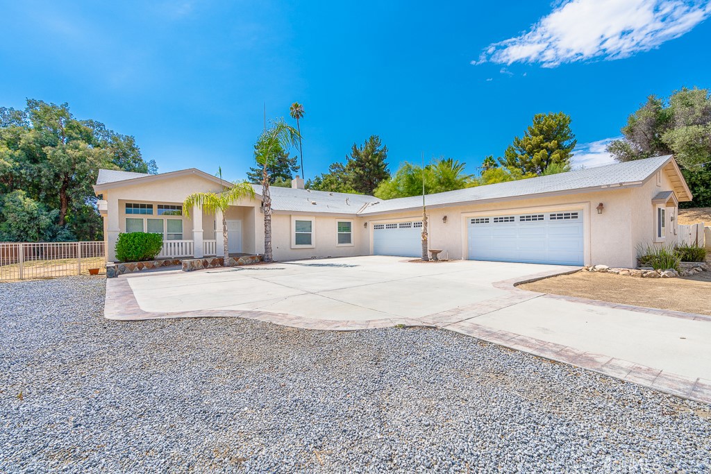 a front view of a house with a yard and a garage