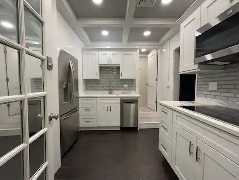 a kitchen with stainless steel appliances a refrigerator sink and microwave