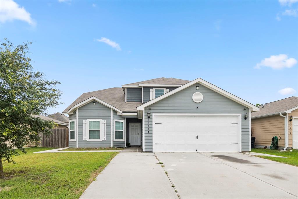 a front view of a house with a yard and garage