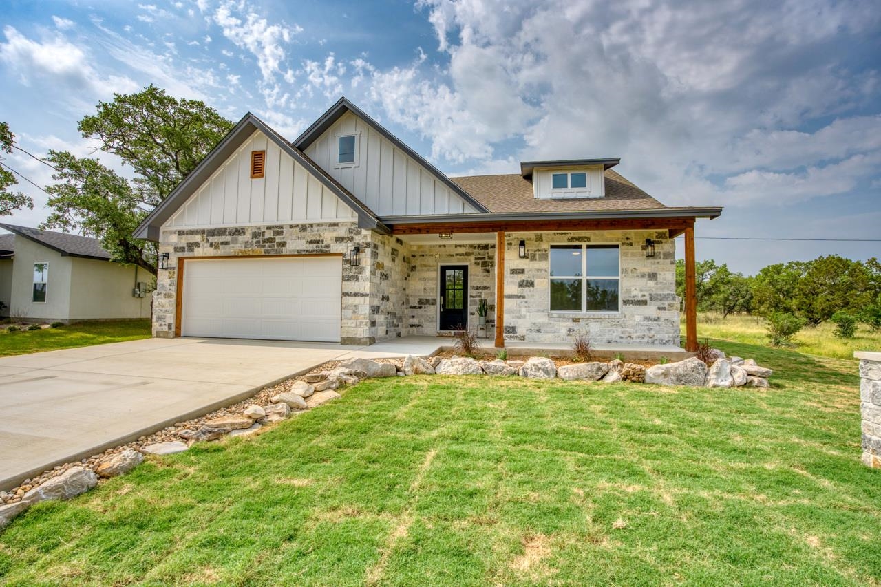 a front view of a house with a yard and garage