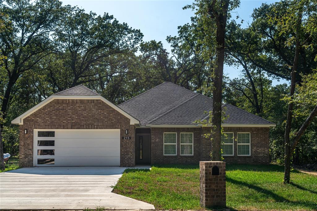 a front view of house with yard and green space