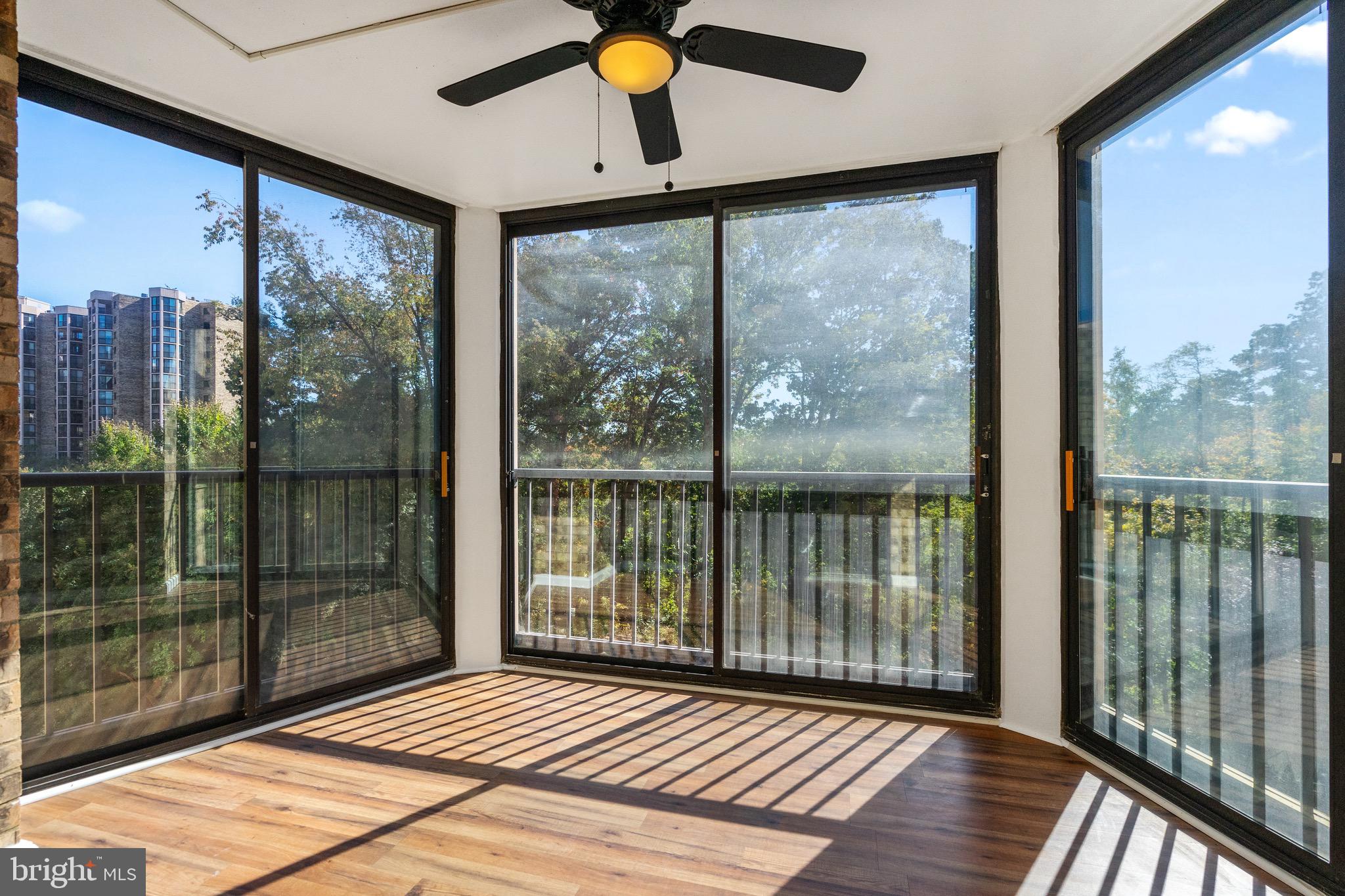 a view of a balcony with wooden floor