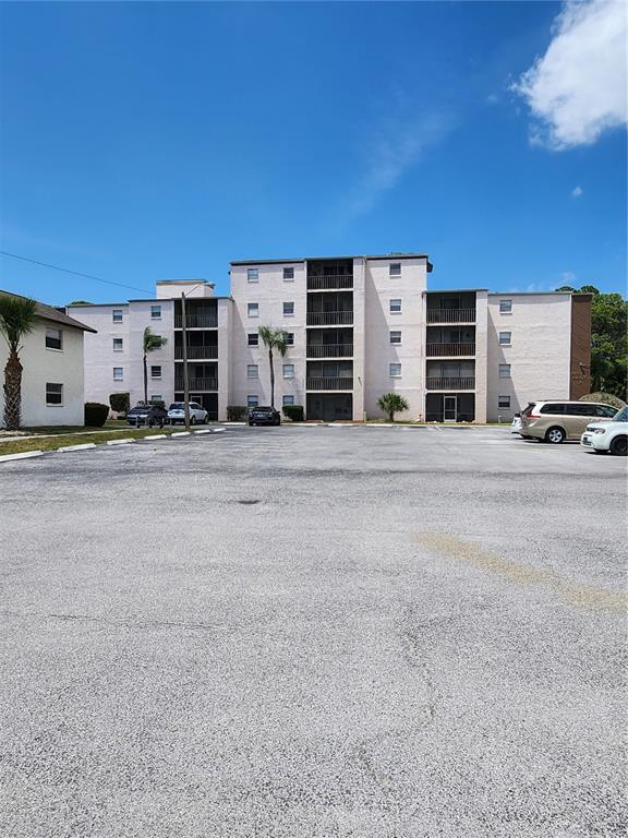 a view of a building with car parked