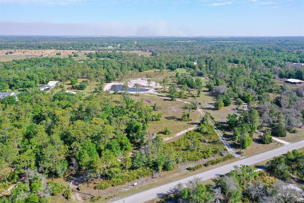 an aerial view of a houses with a yard