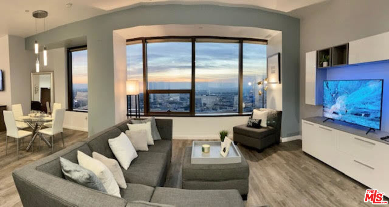 a living room with furniture and large windows