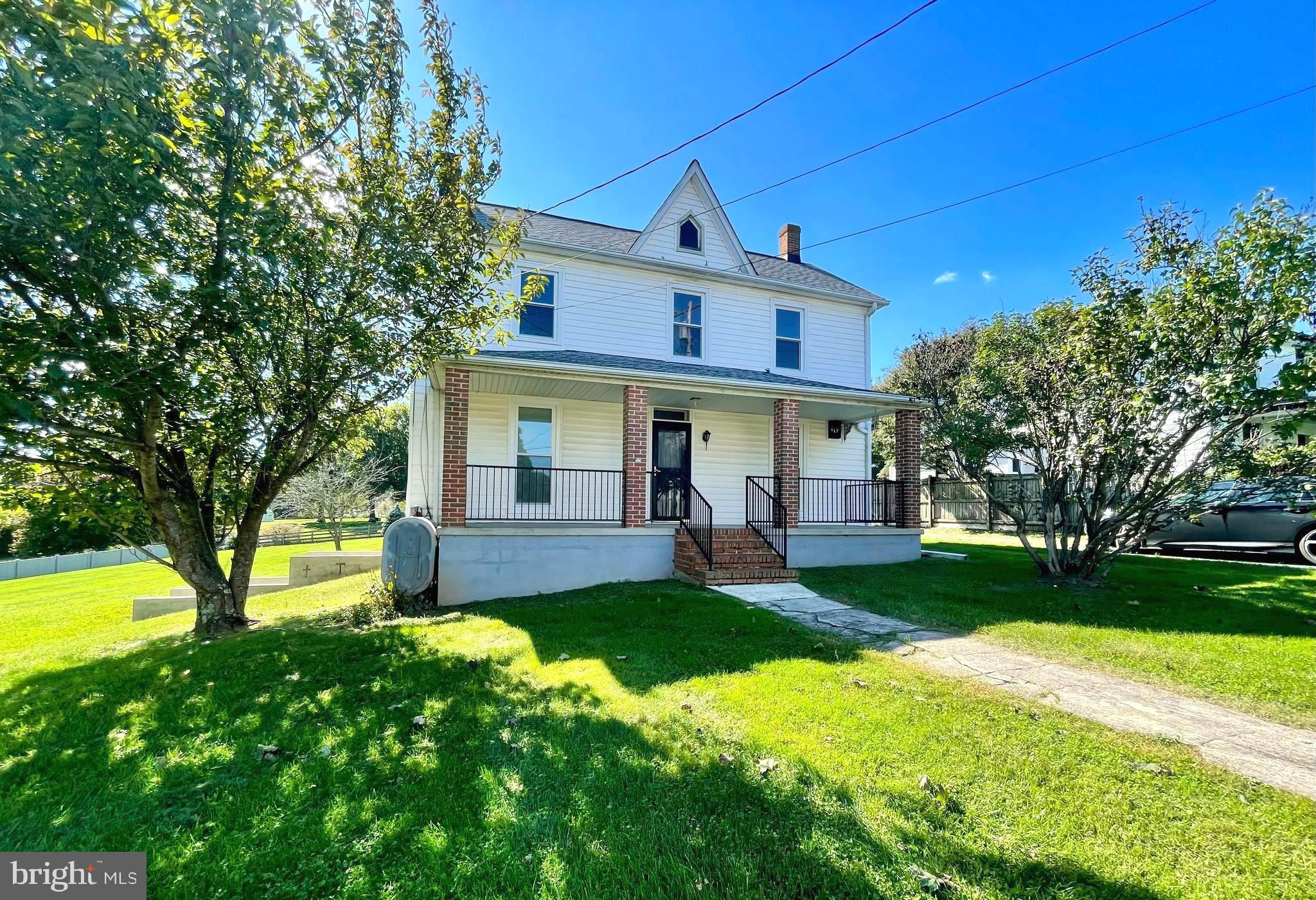 a front view of a house with a yard and porch