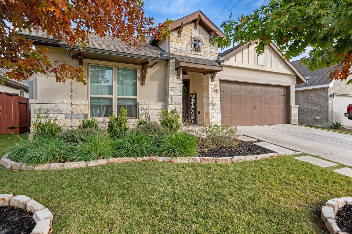 a front view of a house with a garden and yard