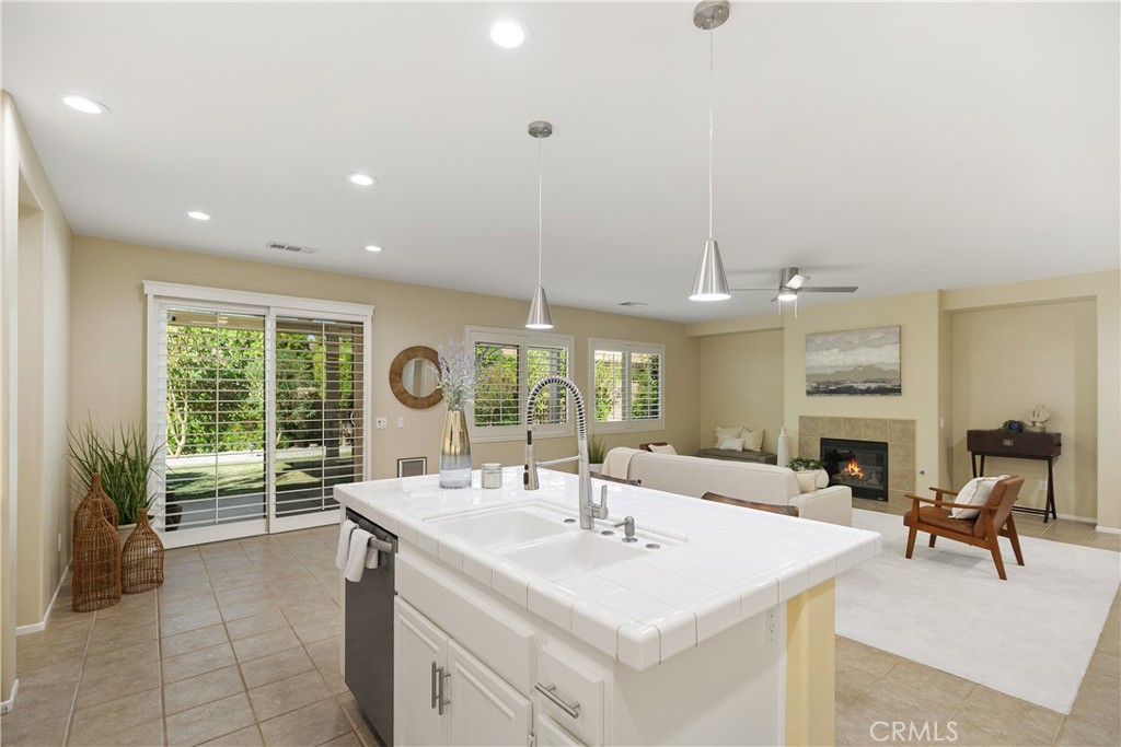 a large kitchen with a large window and a view of living room