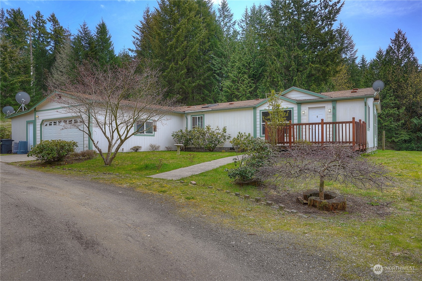 a view of a house with a yard and large trees