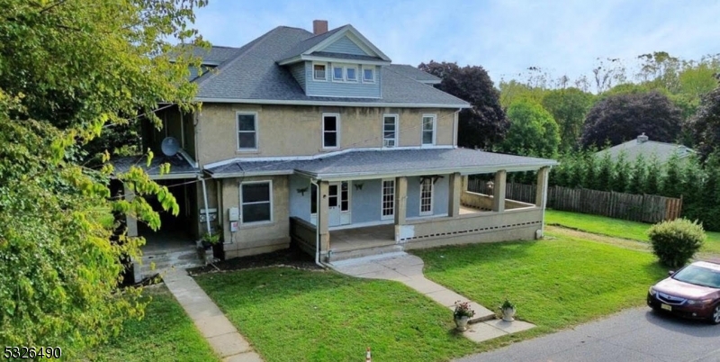 a view of a house with a yard and sitting area