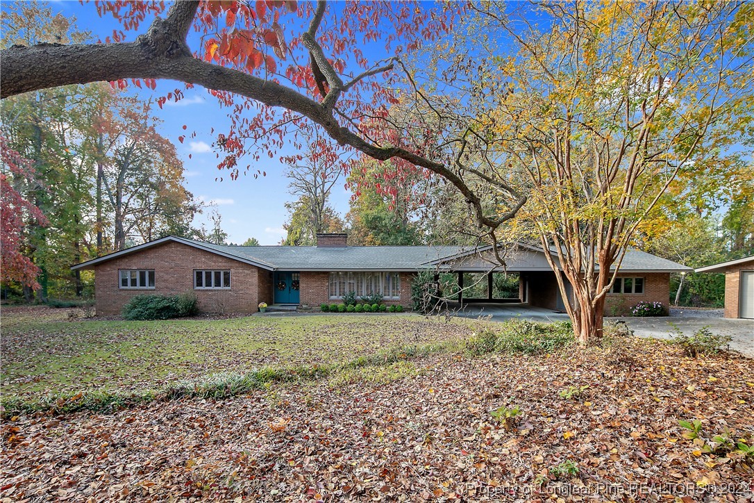 a house that has a tree in front of it