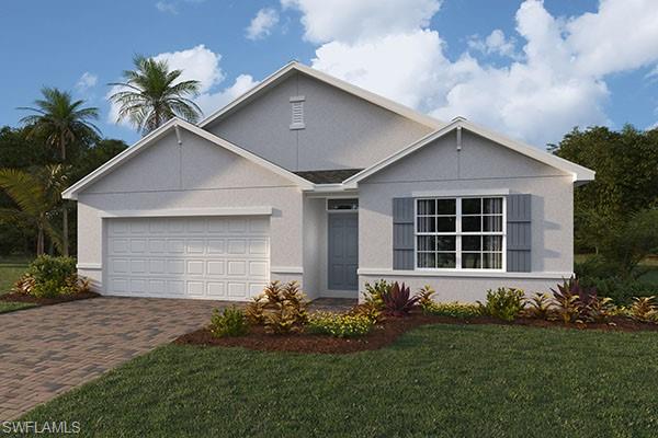 a front view of a house with a garden and yard