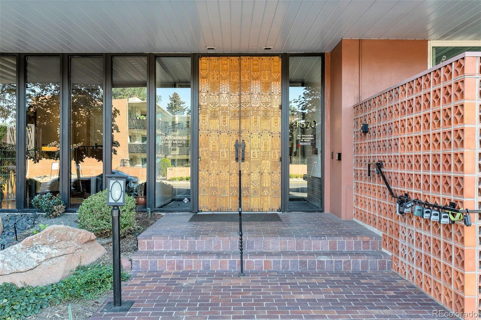 a view of an entryway with a floor to ceiling window and wooden fence