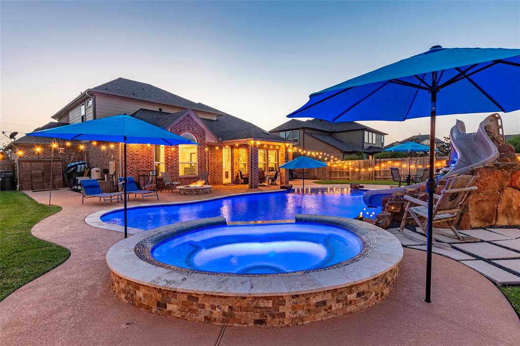 a view of a swimming pool with an outdoor sitting space