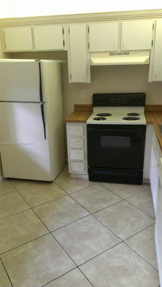 a kitchen with a stove and a refrigerator