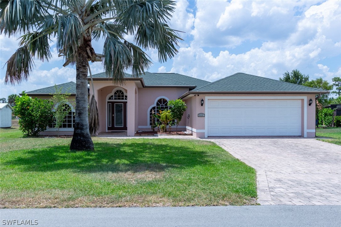 a front view of house with yard and green space