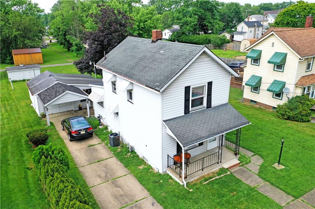 a aerial view of a house with yard and a patio