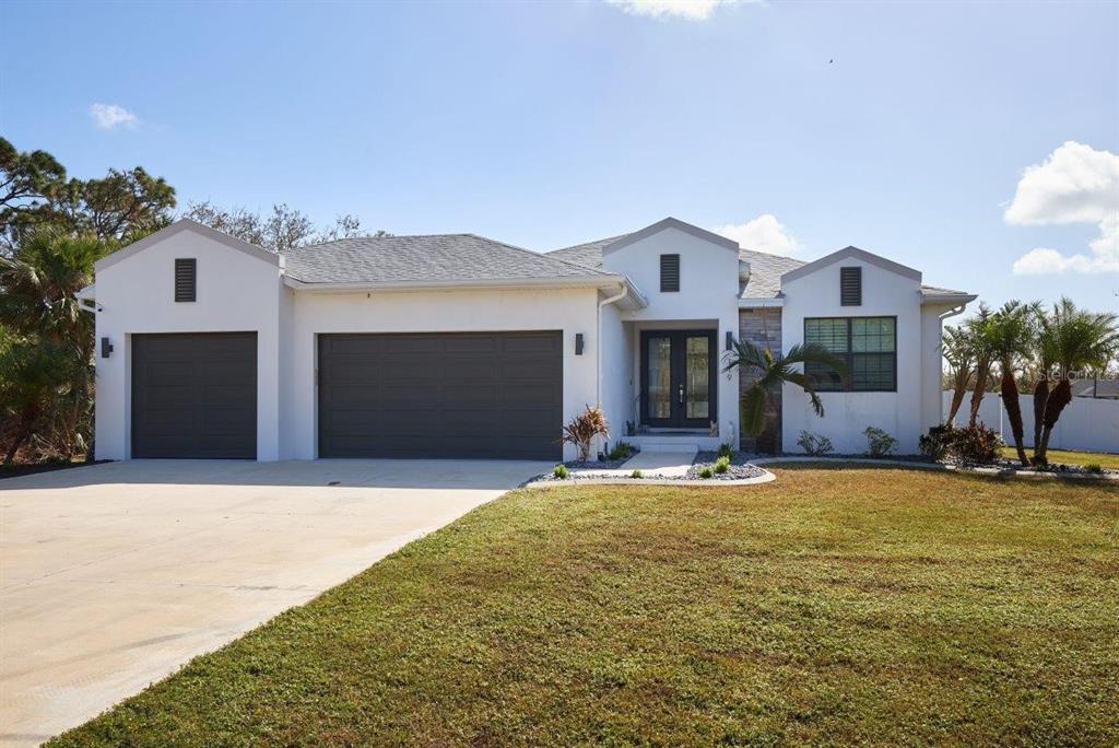 a front view of a house with a yard and garage