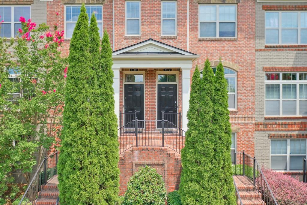 front view of a brick house with a yard