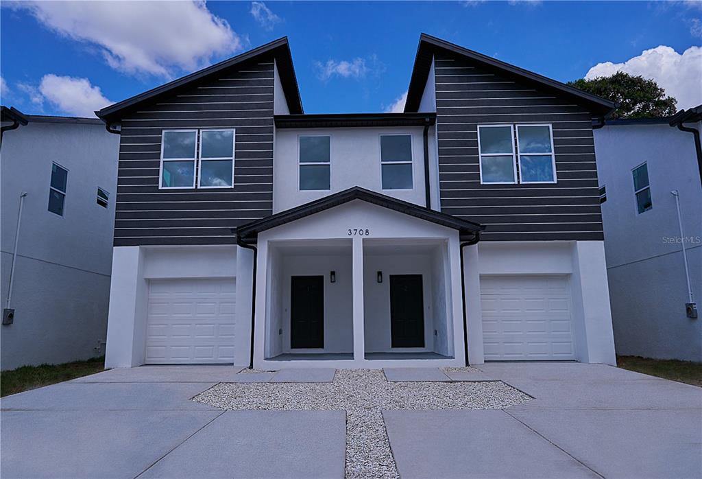 a front view of a house with garage