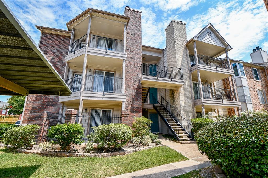 a front view of a residential apartment building with a yard