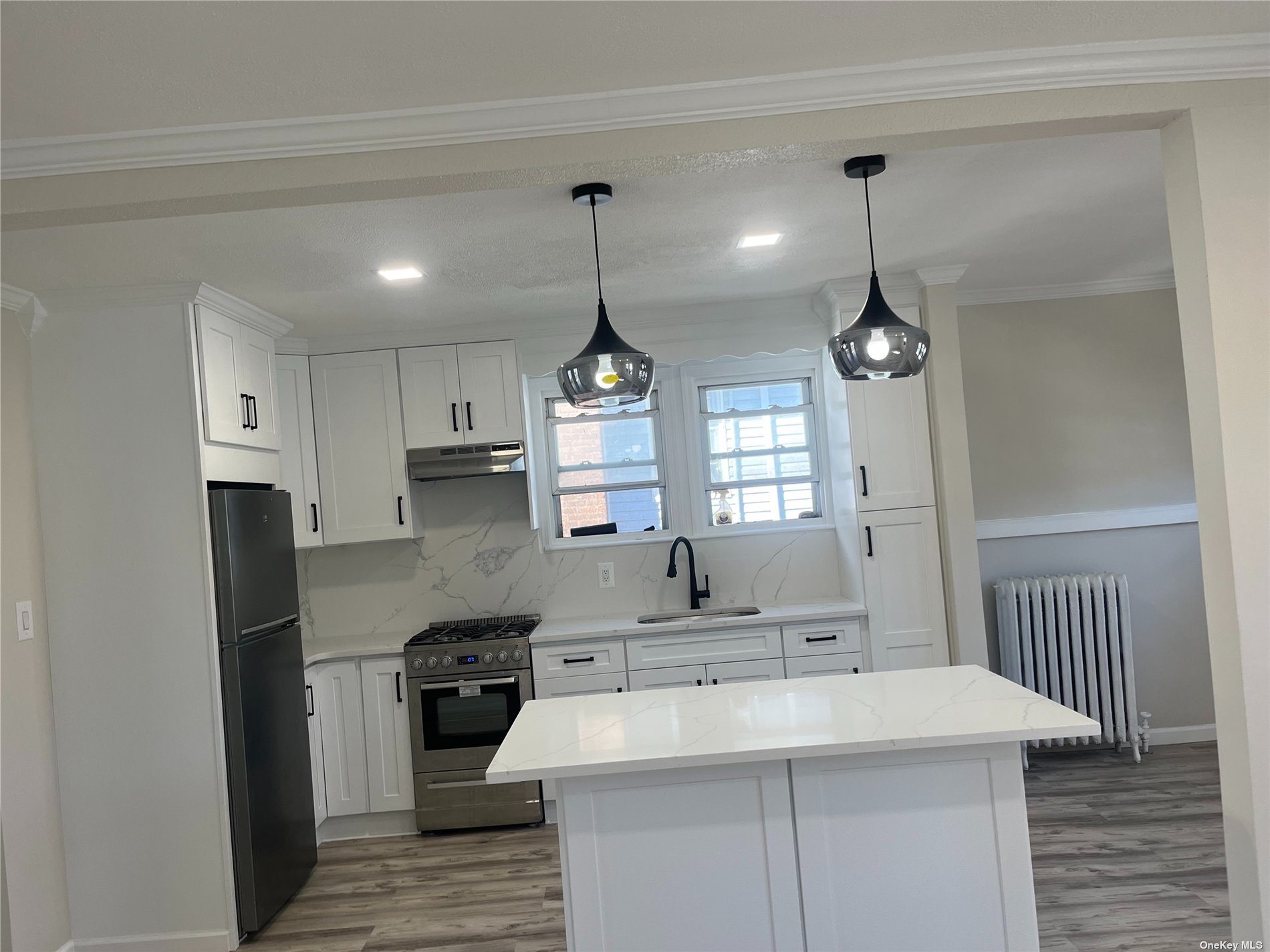 a kitchen with a stove a sink and a refrigerator