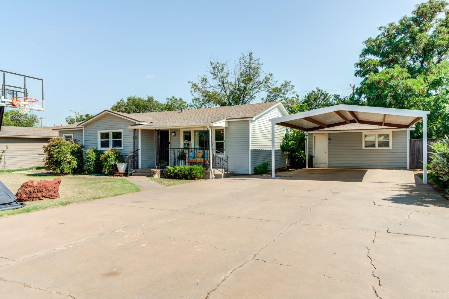 a front view of house with yard outdoor seating and barbeque oven