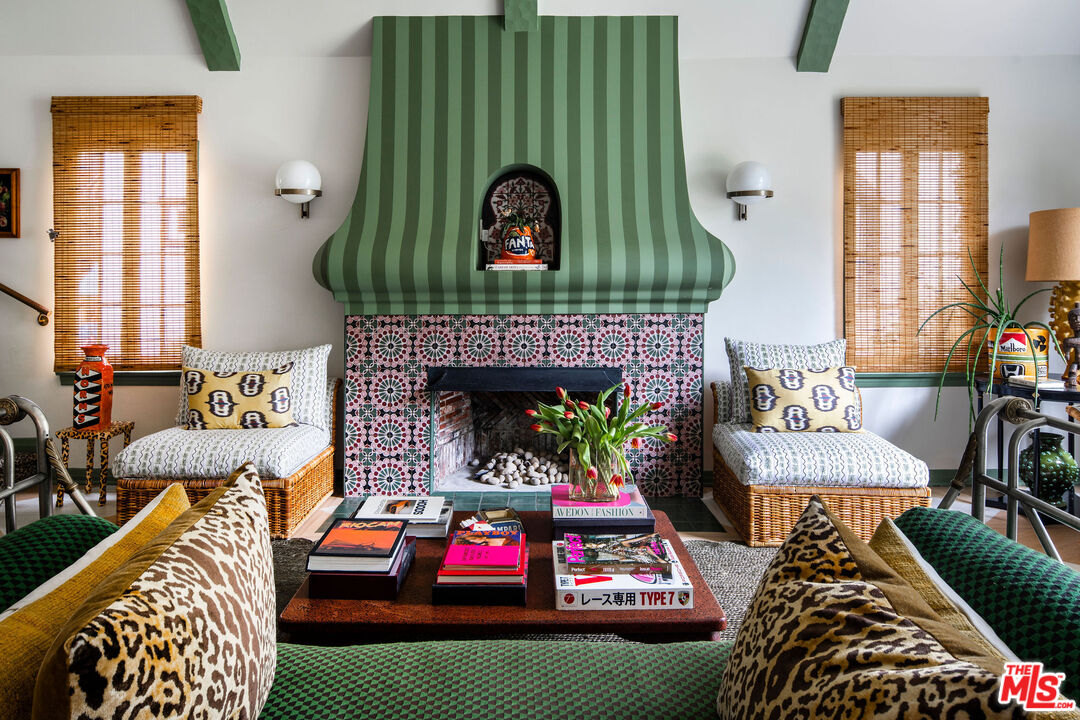 a living room with furniture a rug and a fireplace