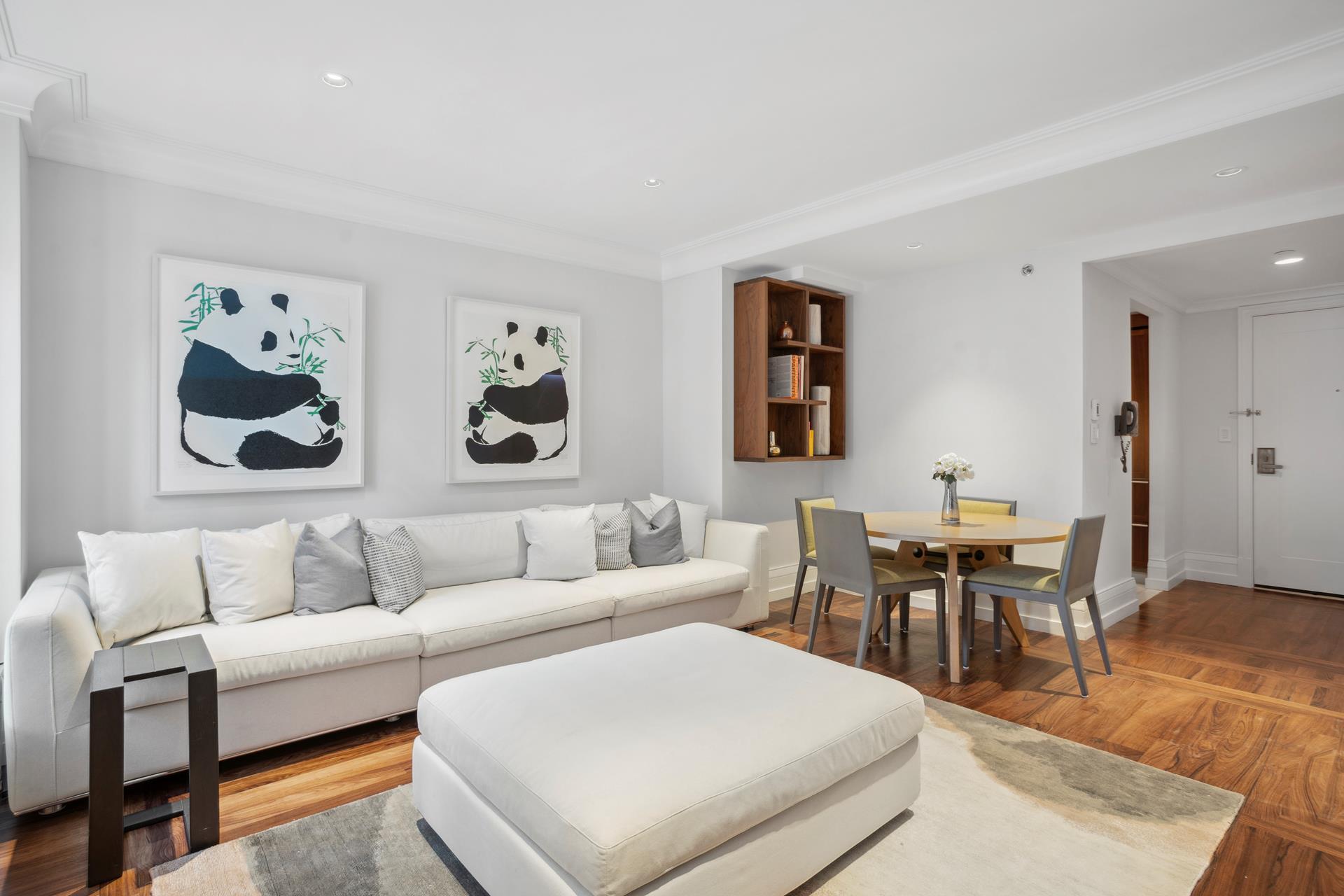 a living room with furniture a rug and a table