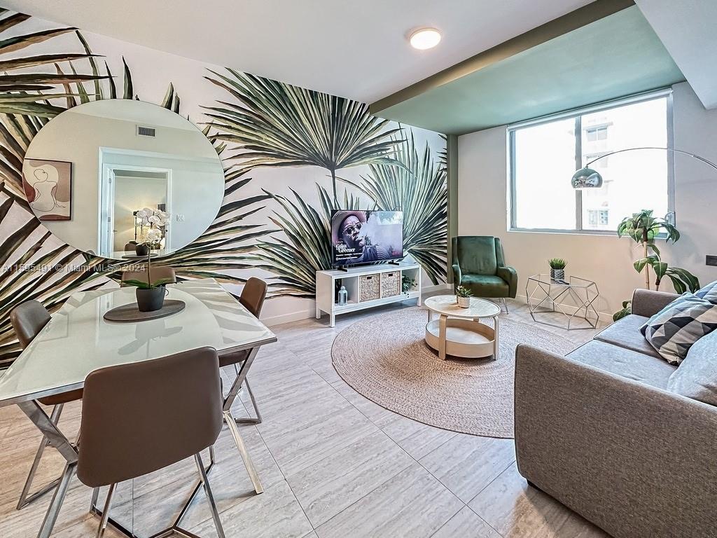 a living room with furniture and a potted plant