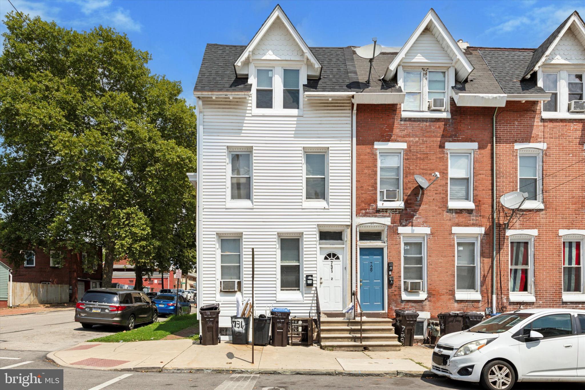 a front view of a residential apartment building with a yard